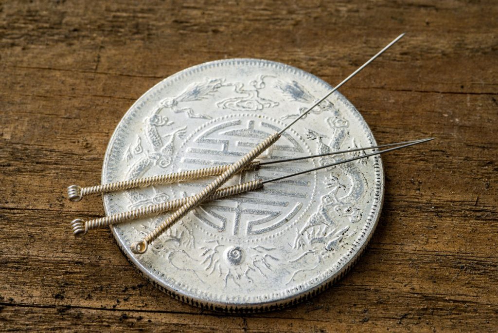 Acupuncture Needles on coin